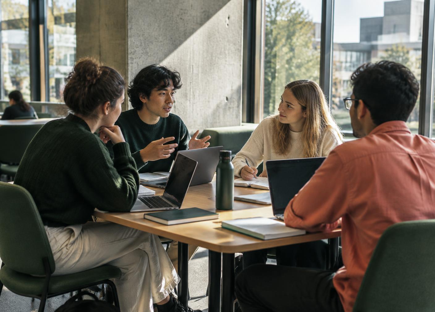 Students collaborating in a university seminar room